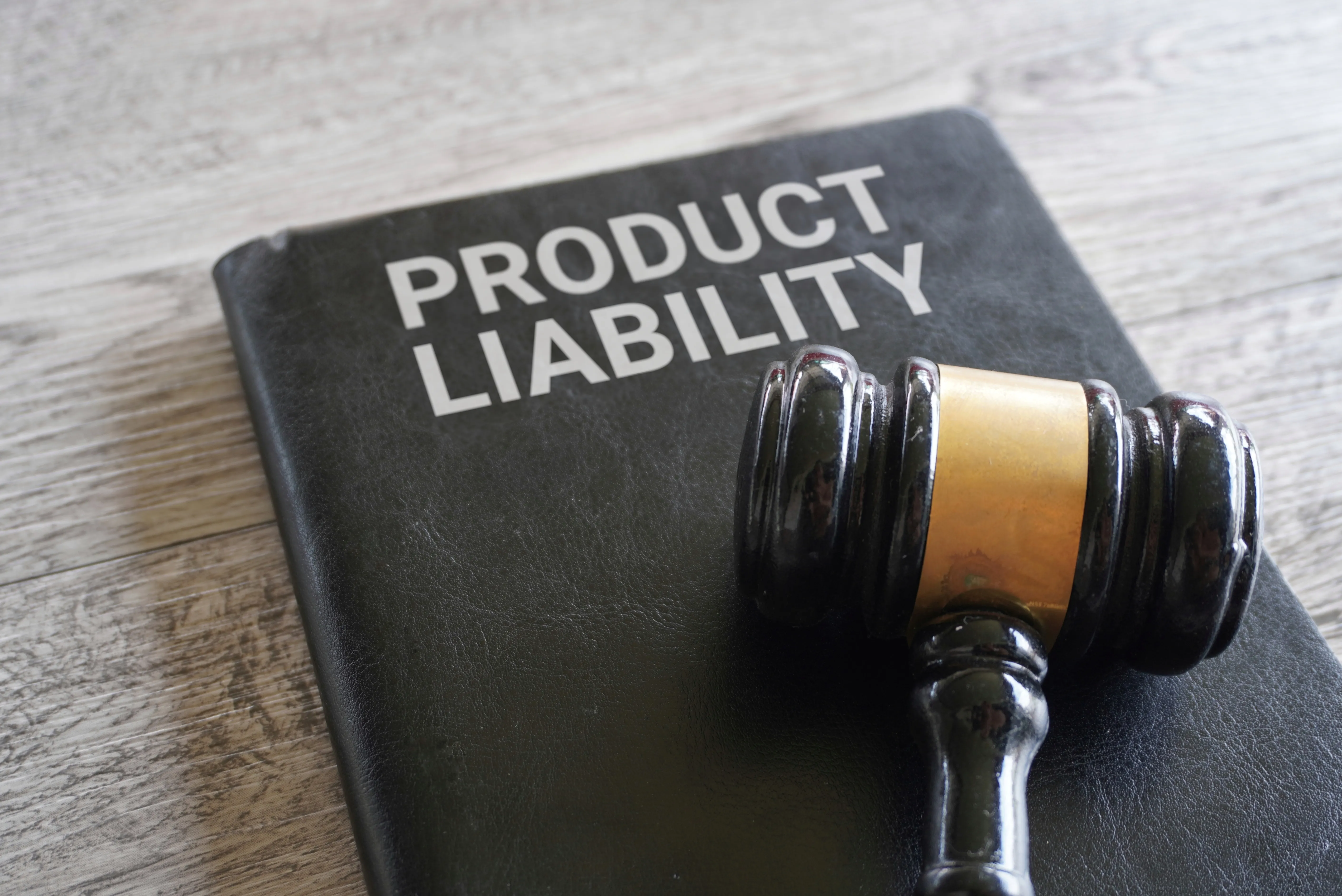 closeup of a judge gavel on a product liability book