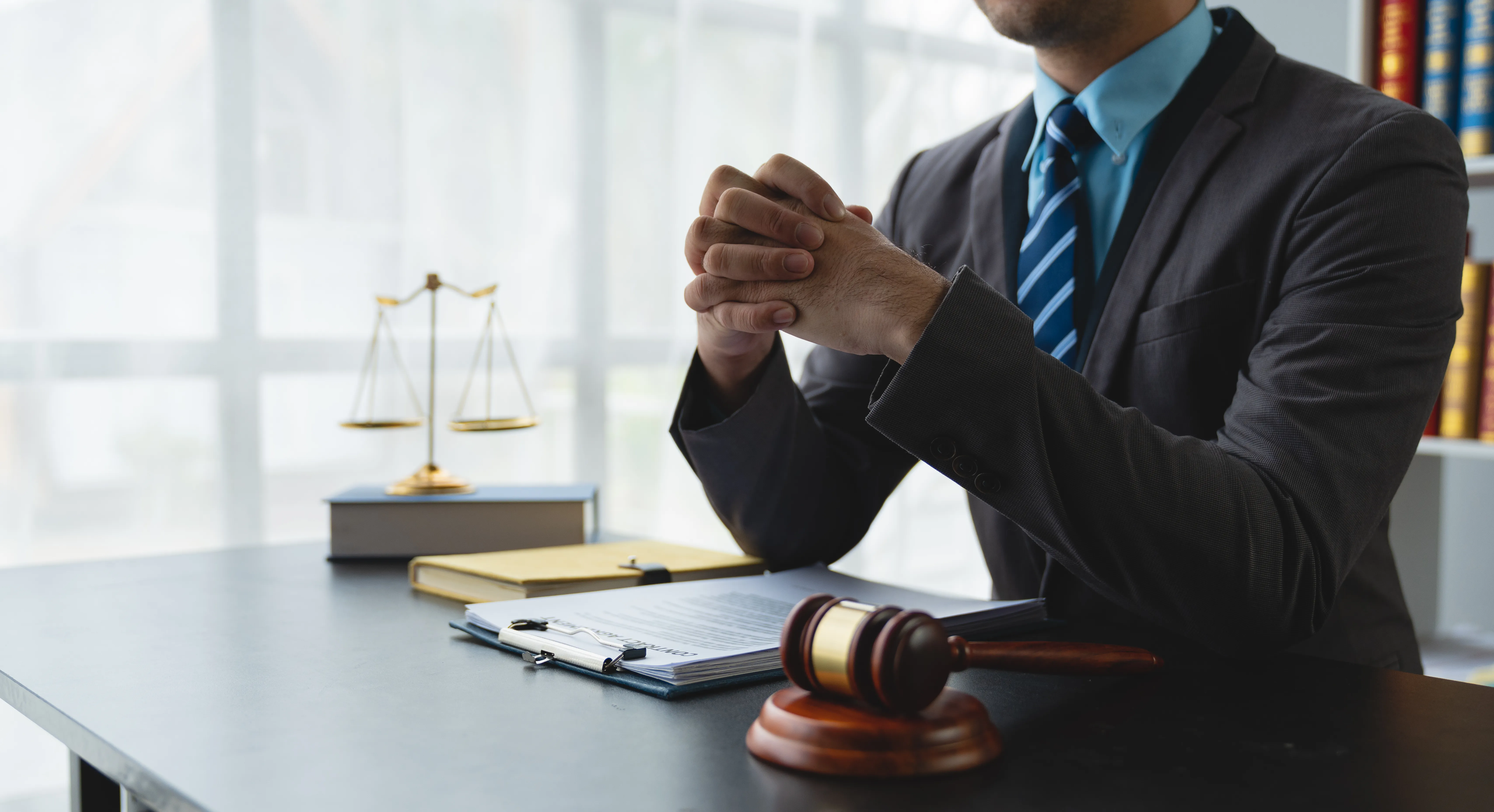 young lawyer or legal advisor sitting holding hands